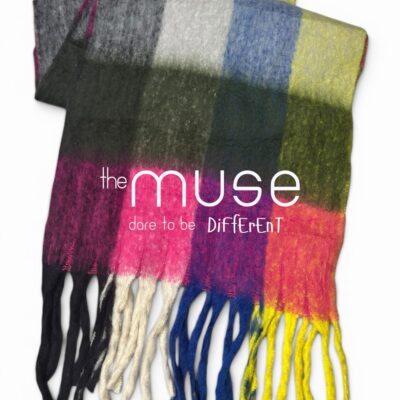 An oversized blanket scarf with a bold block check pattern in neon pink, yellow, blue, and olive green, featuring thick, chunky tassels in black, pink, blue, and yellow.
