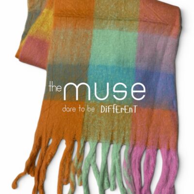 A vibrant, oversized blanket scarf featuring a large-scale, multi-colored block check pattern in shades of orange, purple, green, yellow, and blue, finished with long, thick, twisted tassels.
