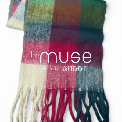 An oversized blanket scarf with a large-scale check pattern in burgundy, emerald green, cobalt blue, and cream, featuring thick, chunky tassels.