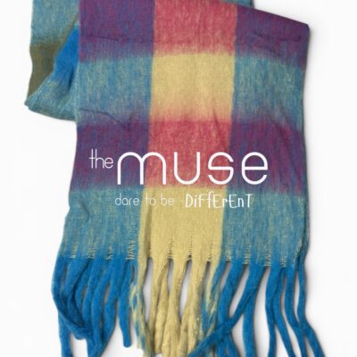 A vibrant, oversized blanket scarf featuring a large-scale check pattern in shades of blue, yellow, and purple with thick, long tassels at the bottom