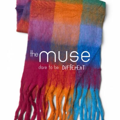 A vibrant, oversized rainbow check blanket scarf with large color blocks of pink, orange, green, blue, and purple, featuring long, thick, multi-colored tassels at the bottom.